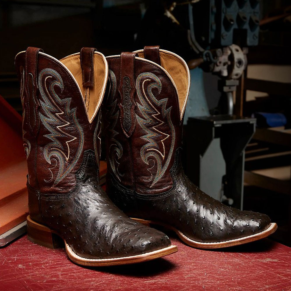 A pair of the Foster 11" Full Quill Ostrich in Sienna brown on a factory table.